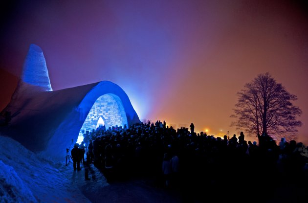 Description: Visitors stand in front of a blue-lit church built of snow during its opening in Mitterfirmiansreut, southern Germany, Wednesday evening, Dec. 28, 2011. The church was opened in the Bavarian Forest tw